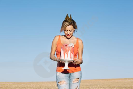 A beautiful woman enjoying a delicious cake, perfect for celebrations, desserts, and lifestyle content