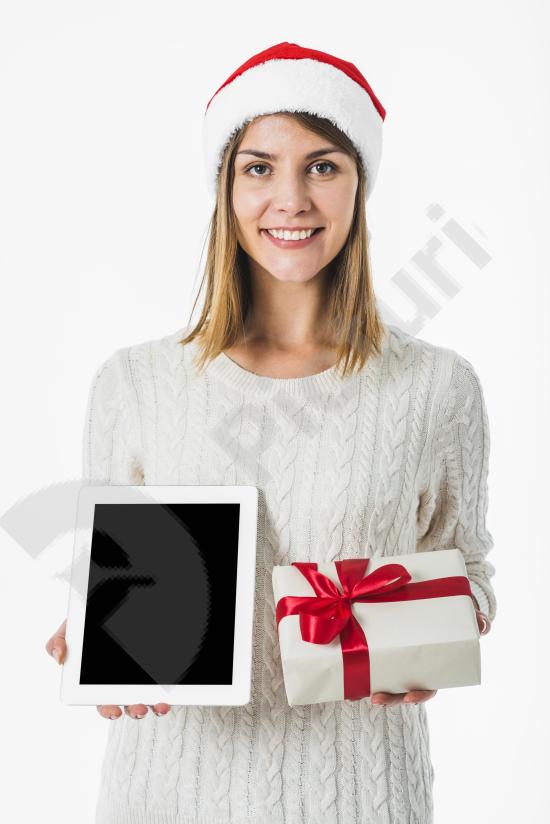 Woman holding a tablet and a gift box, ideal for holiday promotions, online shopping themes, digital gifting, and festive marketing visuals.