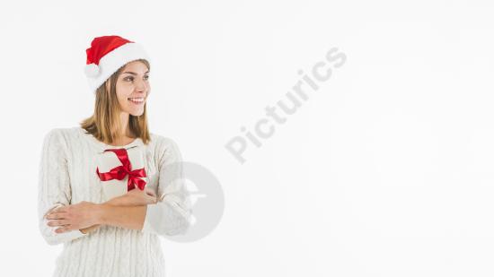 Happy woman in a Santa hat hugging a gift box, ideal for Christmas ads, holiday promotions, and festive seasonal designs.