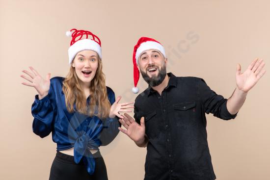 Front view of a young woman and man posing together against a pink background, ideal for lifestyle, fashion, relationship, and people concepts.