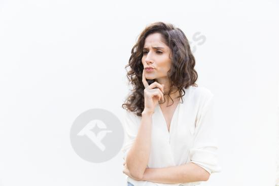 Portrait of a pensive woman touching her face with her finger, looking to the side. Ideal for concepts like thinking, emotions, doubts and lifestyle s...