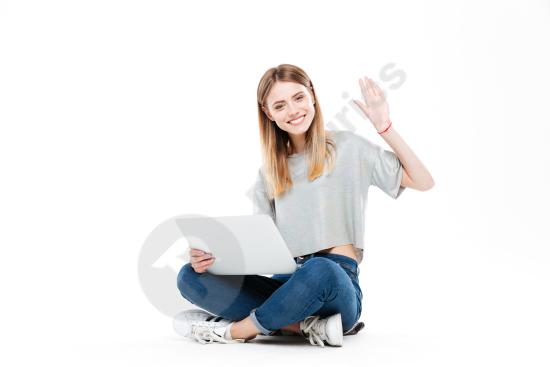 Smiling woman using a laptop computer, representing remote work, productivity, business, and modern digital lifestyle.