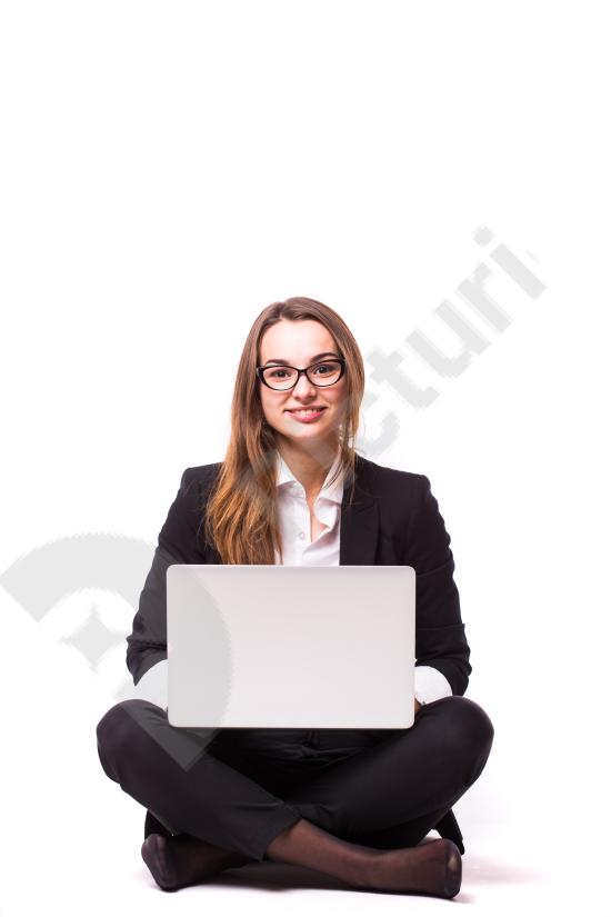 Young businesswoman sitting on the floor using a laptop, representing remote work, startup culture, and modern professional lifestyle.