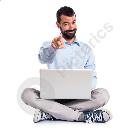 Man holding a laptop and pointing forward, representing presentation, explanation, business communication, and digital work.