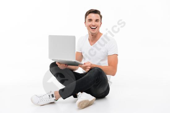Portrait of an excited and amused man working on a laptop, expressing joy, productivity, and modern digital work lifestyle.