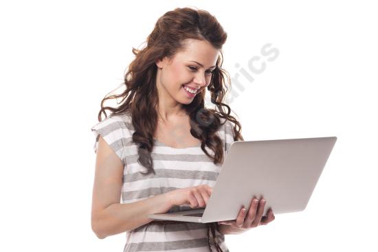 Happy young woman using a laptop, representing remote work, productivity, business, and a modern digital lifestyle.