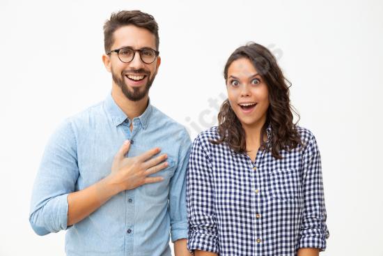 Surprised young couple looking at the camera, expressing shock, reaction, emotion, and spontaneous lifestyle moments.