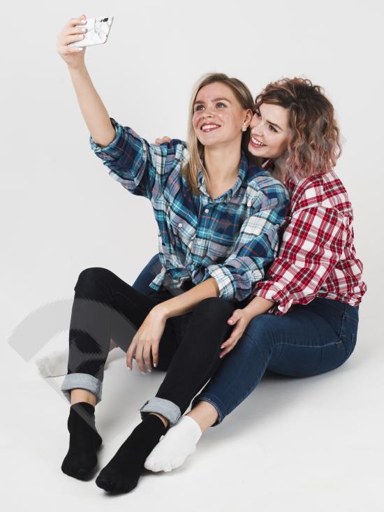 Couple smiling while taking a selfie on Valentine’s Day, representing love, relationship and happiness.