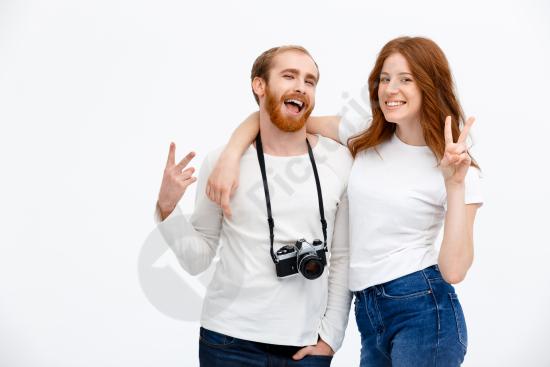Happy adult couple posing with a photo camera, representing photography, shared hobbies, lifestyle, and joyful moments together.