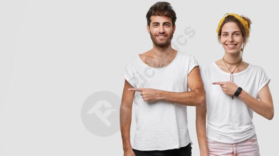 Happy delighted woman and man pointing to the right, showing copy space for promotion, advertising, marketing, and business concepts.