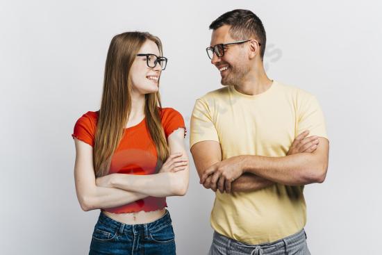 Smiling friends looking at each other, expressing friendship, connection, positive emotions, and happy social lifestyle moments.