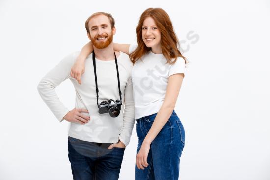 Happy adult couple posing with a photo camera, representing photography, shared hobbies, joyful moments, and lifestyle concepts.