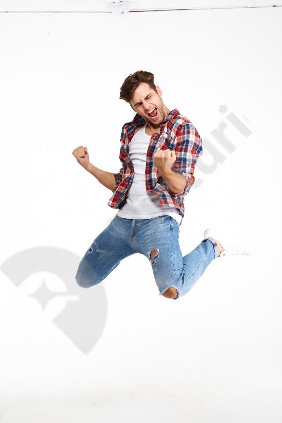 Full length portrait of a young satisfied man celebrating success, showing happiness and achievement, ideal for marketing, business, and lifestyle con...