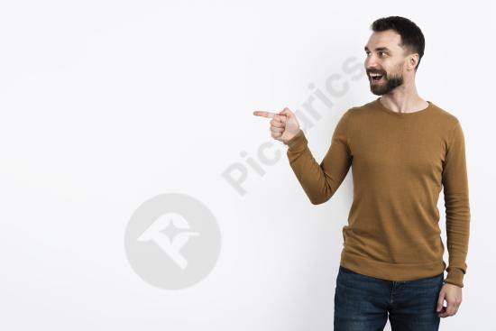 Handsome man pointing while posing with a surprised expression, ideal for advertising, promotions, and expressive marketing concepts.