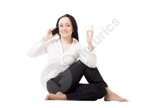 Woman sitting on the floor while talking on her phone, representing communication, casual lifestyle, remote work, or everyday conversation.