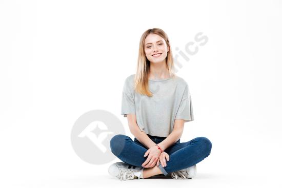 Young woman sitting cross legged, isolated on a clean background, suitable for lifestyle, casual portraits, and modern design projects.