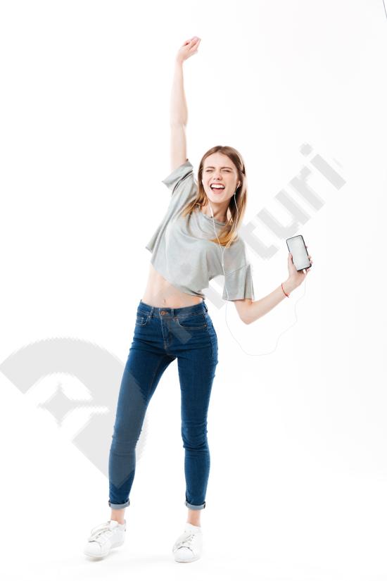 Joyful woman listening to music and dancing, expressing happiness, freedom, and positive energy for lifestyle or entertainment concepts.