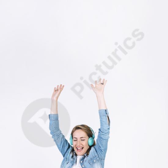 Adult woman listening to music and dancing, expressing joy, freedom, and positive energy in a lifestyle or entertainment concept.
