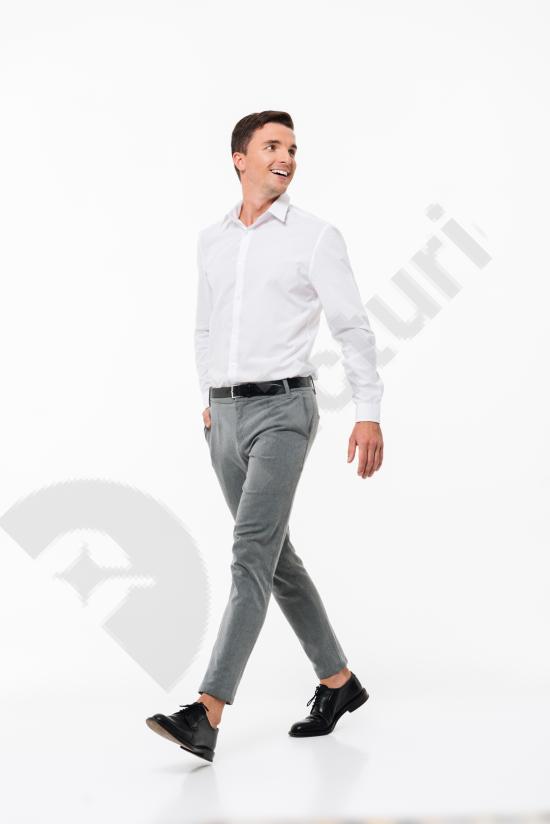 Portrait of a happy smiling man wearing a white shirt. Clean studio look with a friendly expression, ideal for lifestyle and people concepts.