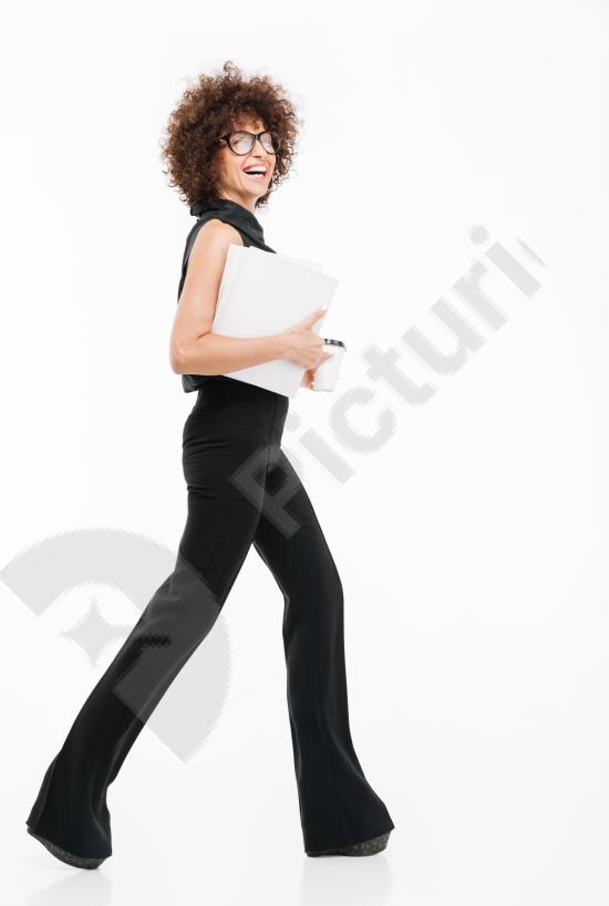 Full-length side view of a young successful businesswoman. Professional and confident look, ideal for corporate, career, and leadership concepts.