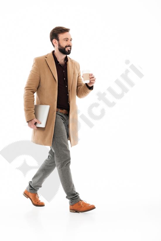 Full-length portrait of a young bearded man posing confidently. Ideal for lifestyle, fashion, and modern male identity concepts on a clean background.