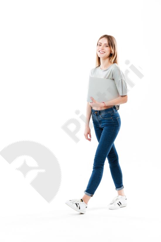 Young woman holding a laptop computer, ideal for technology, business, education, and remote work concepts in a modern lifestyle setting.