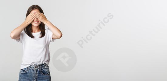 Dreamy beautiful girl smiling with eyes closed as if waiting for a surprise. Soft emotional portrait perfect for anticipation, happiness, and calm con...